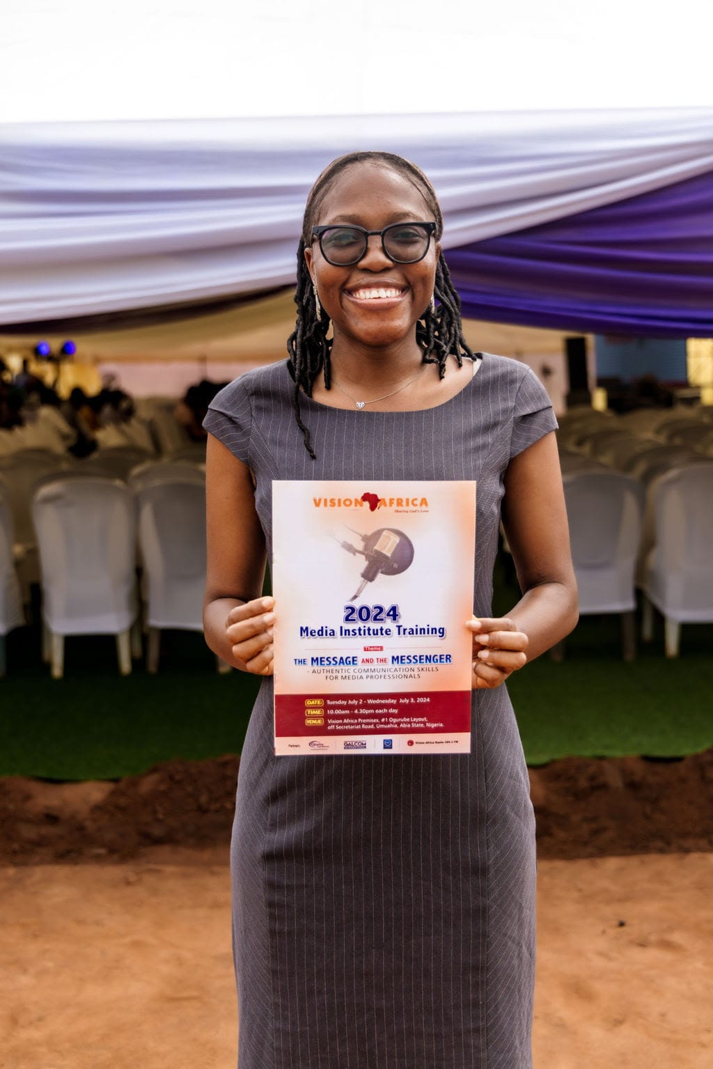Woman holds certificate of completion for Vision Africa's Media Institute 2024