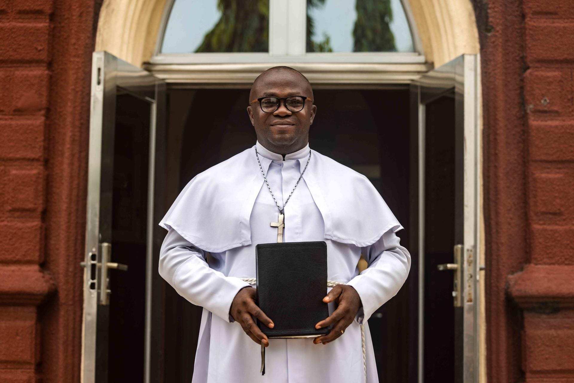 Pastor holding donated Bible from Vision Africa Ministries