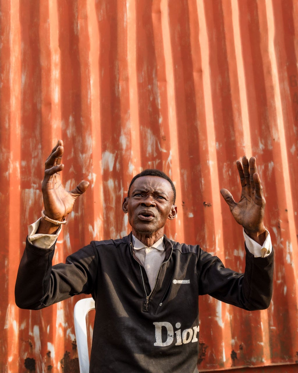 Man lifting hands in praise at Vision Africa | Becoming the Pebble in the Pool